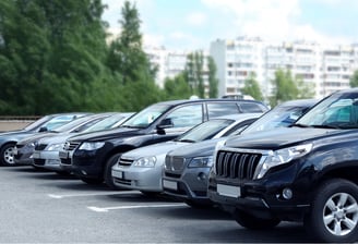 Outdoor parking area with cars aligned, illustrating managed vehicle parking control.