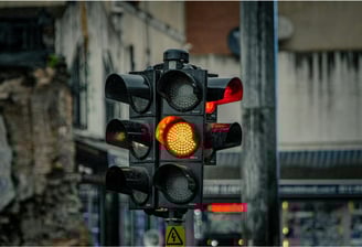 Yellow traffic light in urban intersection managed by centralized signal control platform.