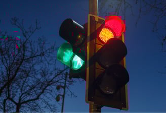Intelligent traffic light glowing red and green at night, used in adaptive signal control systems.