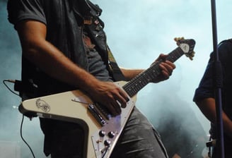 a man playing guitar in a concert