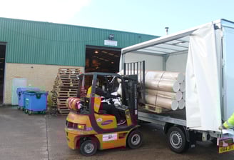 a forklift truck carefully loading a urgent same day delivery