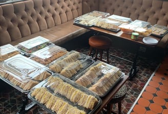 a table with trays of food in a pub