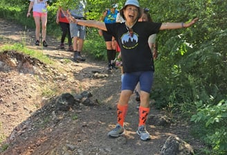 woman in running clothes ahead of other runners
