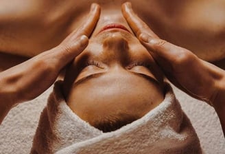 a woman getting a facial massage at a spa