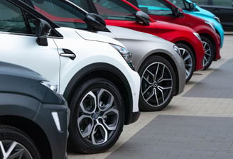 a row of parked cars with a line of parked cars, ready for rent, airport transfer, chauffeur service