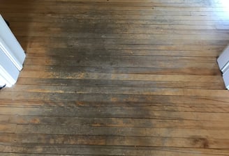 a worn discolored hardwood floor