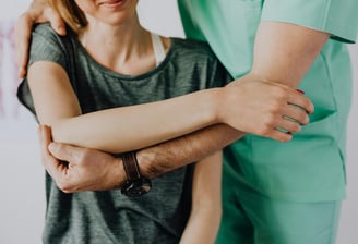 a therapist adjusting a woman's body