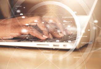 a person typing on a laptop computer screen