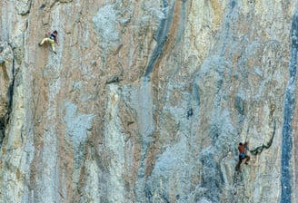 a man climbing a steeple on a mountain