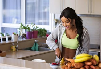 a woman in a yellow top and a banana peeler