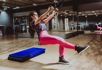 a woman in pink leggings and a pink top