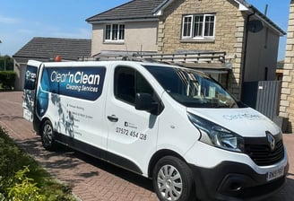 exterior cleaning company van with logo on the side of a driveway