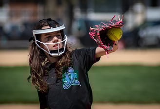 Photo of softball plater catching ball