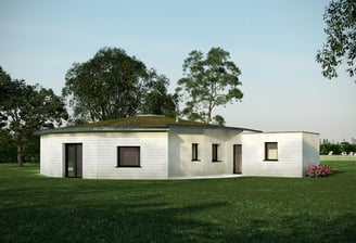 a small white house with a green roof