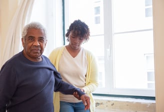 physiotherapy at home for seniors - an elderly man looking happy to be helped by The London Physio