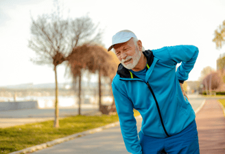 physiotherapy at home for seniors - an elderly man outdoors with back pain