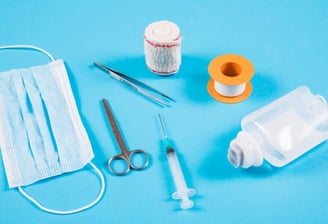 a variety of medical supplies including a bottle of liquid