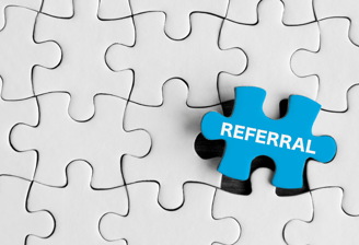 white puzzle with one blue piece with the word "referral" printed on it