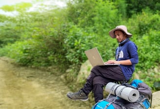 This image captures our founder working for a client while traveling through the mountains