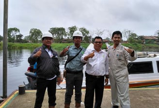 a group of men standing after Buy Oil Boom