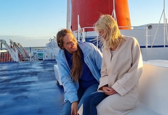 Two friends enjoying each other's company on a ferry to Sweden.