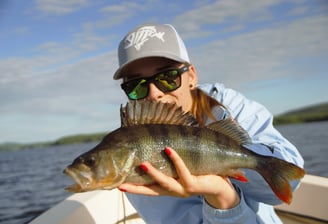 Girl angler displaying her perch catch.