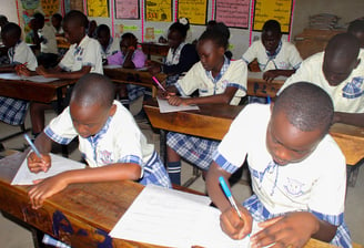 a group of children sitting at desks in a classroom