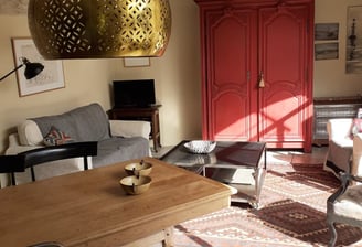 a living room with a table and chairs