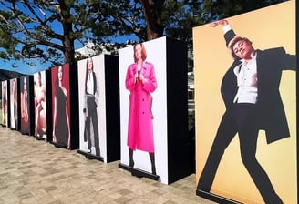 a row of posters with a man in a tuxedo | CORPORATE EVENT | The Kabir Company