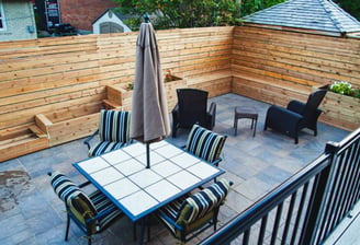 a patio with a table and chairs and umbrellas