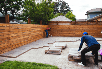 a man and woman are building a patio