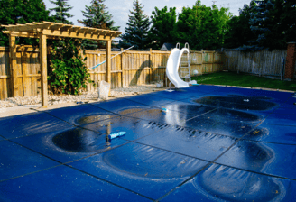 a pool with a slider and a slider in the middle of the pool