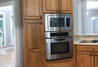 a kitchen with a stove and oven in it