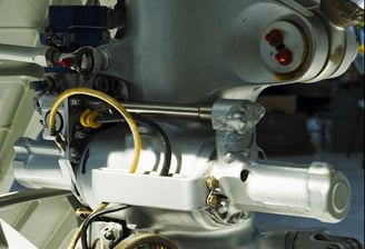 Close-up view of a metal mechanical component, likely part of an aircraft's landing gear assembly.