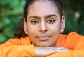 a woman with a bright orange shirt and a black shirt