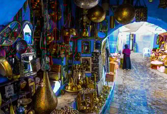 a woman in a blue room with a lot of gold