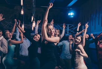 Large private group dancing and celebrating during a custom nightlife crawl on Fremont Street in Downtown Las Vegas