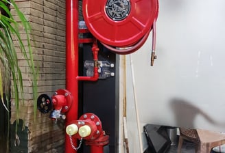 a red fire hydrant sitting on a workplace