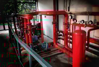 a red fire hydrant with pipes maintenance