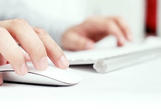 Hands operating a keyboard and mouse