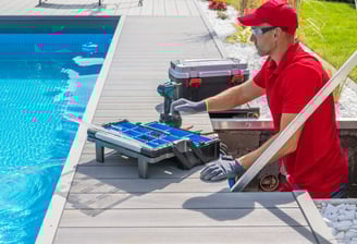 a man in a red shirt is using a pool