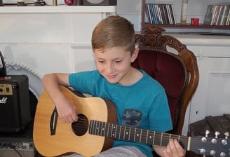 A boy playing guitar