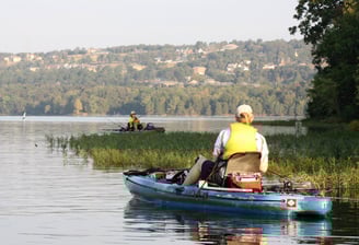 two people in a life jacket is sitting in a boat