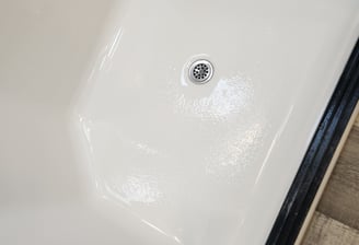 bottom of a white shower with a fiberglass repair in longview texas