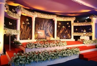 Elegant floral wedding stage backdrop with soft lights by Amika Weddings, Pune-based wedding decorators