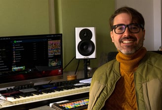 a man in a jacket and glasses is smiling