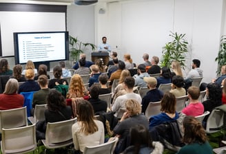 A design professional delivering a talk at a design conference