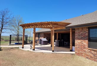 a back patio with a pure cedar pergola roof