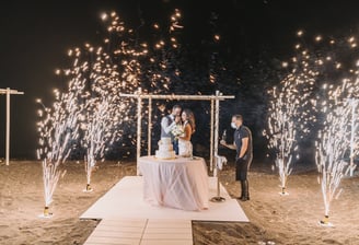 Fireworks creating a magical backdrop as the bride and groom cut their wedding cake.