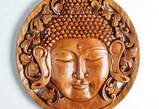 a wooden carving of a buddha statue